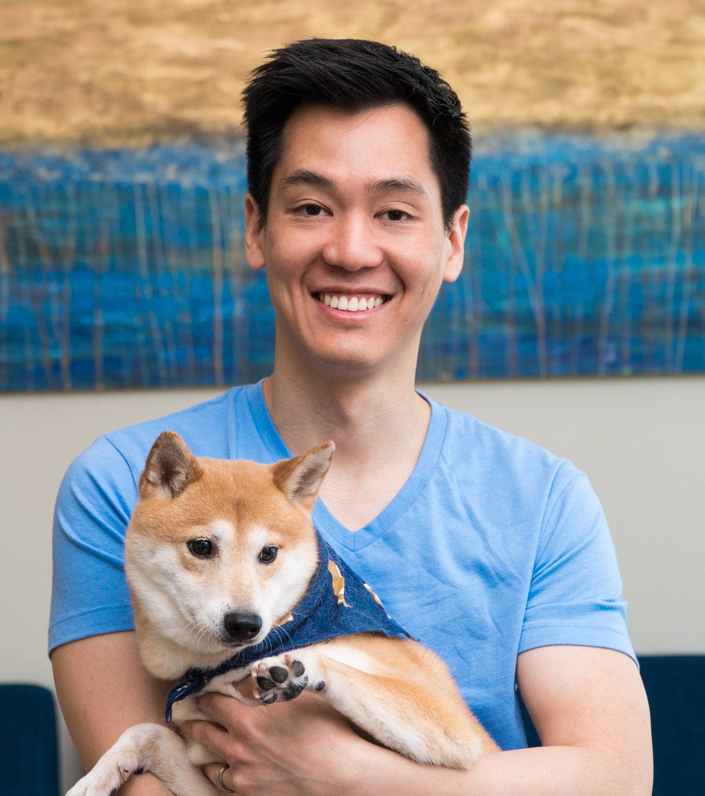 Dr. Bryan Hsu holding his Shiba Inu